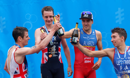 STOCKHOLM - JUL 02, 2016: The medalist triathletes Alistair and Jonathan Brownlee, Pierre Le Corre and Fernando Alarza drinking champagne on the podium in the Men's ITU World Triathlon series event July 02, 2016 in Stockholm, Swedenのeditorial素材