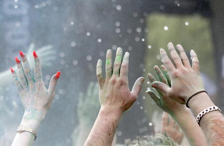 STOCKHOLM, SWEDEN - MAY 22, 2016: Closeup of hands and color powder in the air in the air in the Color Run Event in Sweden, May 22, 2016のeditorial素材