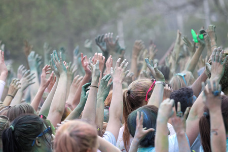 STOCKHOLM, SWEDEN - MAY 22, 2016: Happy audience with arms in the air and color powder in the air in the Color Run Event in Sweden, May 22, 2016のeditorial素材