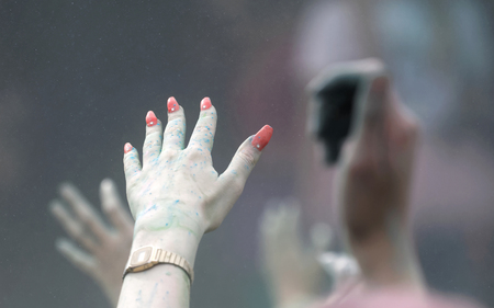 STOCKHOLM, SWEDEN - MAY 22, 2016: Closeup of hand with nail polish and color powder in the air in the Color Run Event in Sweden, May 22, 2016のeditorial素材