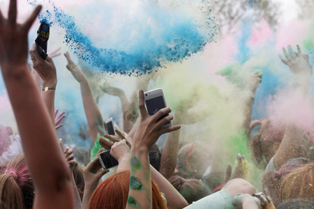 STOCKHOLM, SWEDEN - MAY 22, 2016: Closeup of happy hands throughing blue color powder in the air in the Color Run Event in Sweden, May 22, 2016のeditorial素材