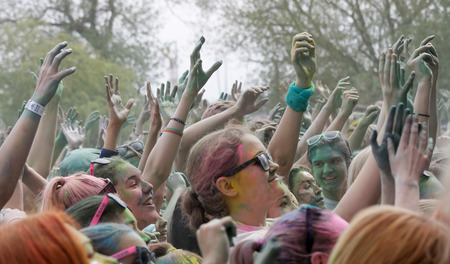 STOCKHOLM, SWEDEN - MAY 22, 2016: Happy audience with arms in the air and color powder in the air in the Color Run Event in Sweden, May 22, 2016のeditorial素材