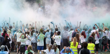 STOCKHOLM, SWEDEN - MAY 22, 2016: Happy audience with arms in the air and color powder in the air in the Color Run Event in Sweden, May 22, 2016のeditorial素材