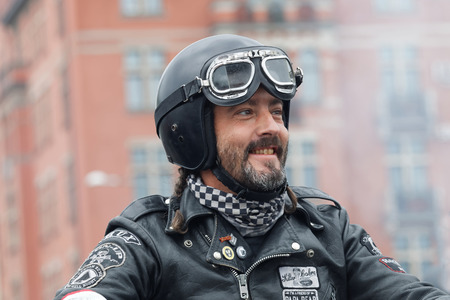 STOCKHOLM, SWEDEN - SEPT 03, 2016: Closeup of smiling biker wearing leather clothes at the Mods vs Rockers event at the St:Eriks bridge, Stockholm, Sweden, September 02, 2016のeditorial素材
