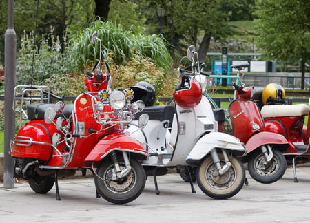 STOCKHOLM, SWEDEN - SEPTEMBER 03, 2016: Three beautiful red and white retro vespa scooters parked before the start of the Mods vs Rockers event at the Saint Eriks bridge, Stockholm, Sweden, September 03, 2016のeditorial素材