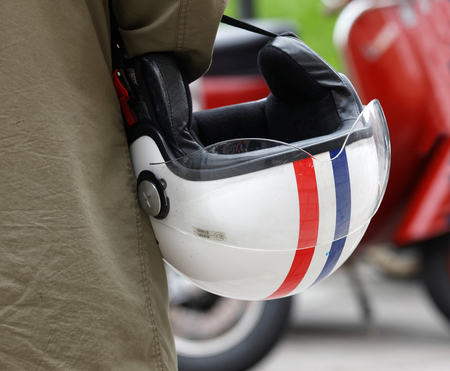 STOCKHOLM, SWEDEN - SEPTEMBER 03, 2016: Closeup of a retro helmet carried by a man, before the start of the Mods vs Rockers event at the Saint Eriks bridge, Stockholm, Sweden, September 03, 2016のeditorial素材