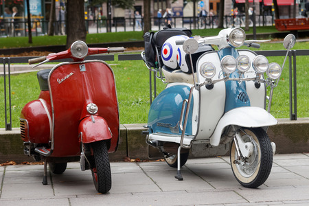 STOCKHOLM, SWEDEN - SEPTEMBER 03, 2016: Two beautiful red and blue/white retro vespa scooters parked before the start of the Mods vs Rockers event at the Saint Eriks bridge, Stockholm, Sweden, September 03, 2016のeditorial素材