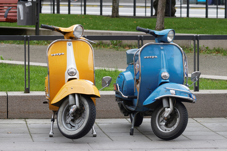 STOCKHOLM, SWEDEN - SEPTEMBER 03, 2016: One yellow and one blue retro vespa scooters parked before the start of the Mods vs Rockers event at the Saint Eriks bridge, Stockholm, Sweden, September 03, 2016のeditorial素材