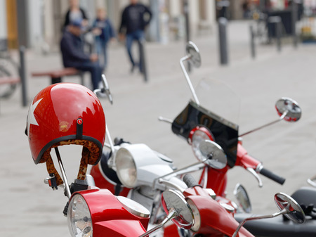 STOCKHOLM, SWEDEN - SEPTEMBER 03, 2016: Red shining retro helmet on the handlebar of a vespa scooter, before the start of the Mods vs Rockers event at the Saint Eriks bridge, Stockholm, Sweden, September 03, 2016のeditorial素材