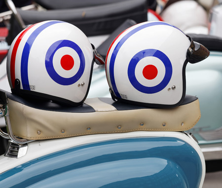 STOCKHOLM, SWEDEN - SEPTEMBER 03, 2016: Two retro helmets on the saddle of a vespa scooter, before the start of the Mods vs Rockers event at the Saint Eriks bridge, Stockholm, Sweden, September 03, 2016のeditorial素材