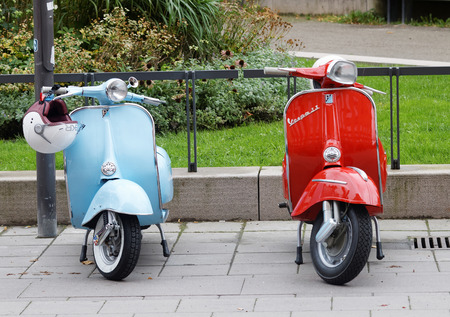 STOCKHOLM, SWEDEN - SEPTEMBER 03, 2016: One blue and one red retro vespa scooters parked before the start of the Mods vs Rockers event at the Saint Eriks bridge, Stockholm, Sweden, September 03, 2016のeditorial素材