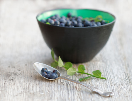 Blueberry in a bowl and a silver spoone. Short focusの写真素材