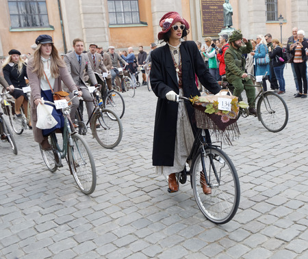 STOCKHOLM - SEPT 24, 2016: Cycling women dressed in old fashioned dress in the Bike in tweed event September 24, 2016 in Stockholm, Swedenのeditorial素材