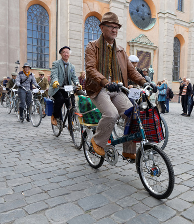 STOCKHOLM - SEPT 24, 2016: Man cycling on a mini bicycle dressed in old fashioned clothes in the Bike in tweed event September 24, 2016 in Stockholm, Swedenのeditorial素材