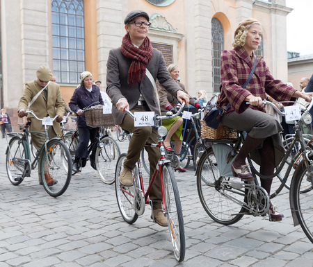 STOCKHOLM - SEPT 24, 2016: Cycling women and men dressed in old fashioned clothes in the Bike in tweed event September 24, 2016 in Stockholm, Swedenのeditorial素材