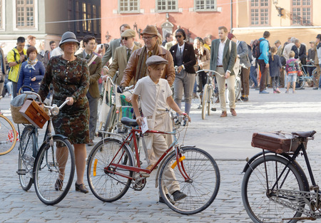 STOCKHOLM - SEPT 24, 2016: Many people in old fashioned clothes in a queue leading their bicycles in the Bike in Tweed event September 24, 2016 in Stockholm, Swedenのeditorial素材
