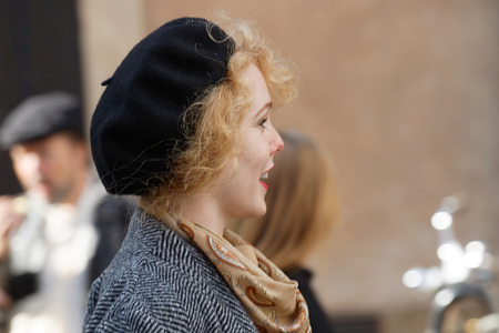 STOCKHOLM - SEPT 24, 2016: Smiling woman with red hair wearing hat and old fashined clothes in the Bike in Tweed event September 24, 2016 in Stockholm, Swedenのeditorial素材