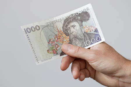 Hand holding swedish 1000 SEK bank note with the swedish king Gustav Vasa, layout before 2016の写真素材