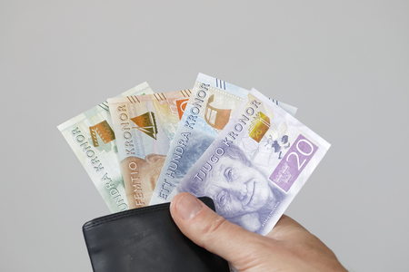 Swedish currency in a black wallet and a hand, new layout 2016の写真素材