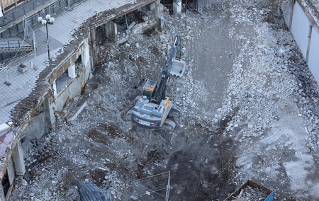 STOCKHOLM, SWEDEN - OCT 30, 2016: An excavator tear down the fameous area Slussen in central Stockholm, preparing for the new buildings in October 30, 2016 in Stockholm, Swedenのeditorial素材