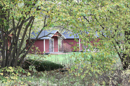 Small red cottages surrounded by hazel treesの写真素材