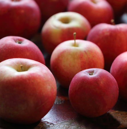 Group of red tasty apples  on a plate, very short depth of focusの写真素材