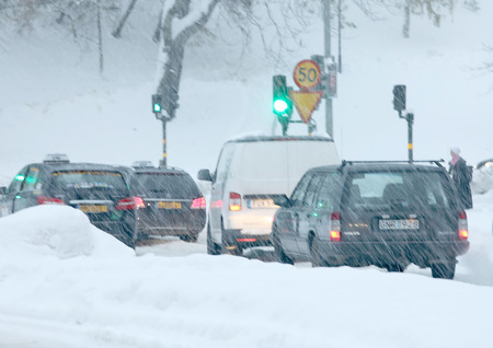 STOCKHOLM, SWEDEN - NOV 10, 2016: Defocused image of snow chaos in the traffic in central Stockholm. Cars covered with snow November 10, 2016 in Stockholm, Swedenのeditorial素材
