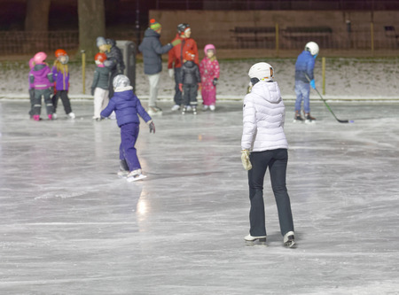 STOCKHOLM, SWEDEN - DEC 03 2016: Children and adults skating in the park during the night. Vasaparken, Stockholm, Swedenのeditorial素材