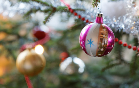 Christmas decorations like balls and christmas tinsel in the Christmas treeの写真素材