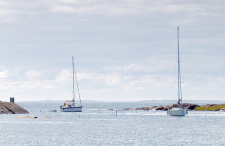 ECKEROE, FINLAND - JUL 14, 2016: Two sailboats on the glittering blue sea a summer day in the archipelago. July 14, 2016 in Eckeroe, Finlandのeditorial素材