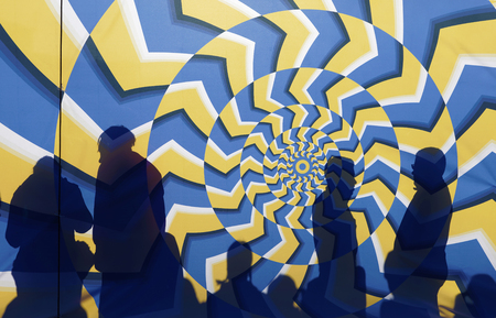 STOCKHOLM, SWEDEN - MAR 25, 2017: Silhouette of people behind a colorful, psychedelic,
abstract startgate waiting for the start in the Stockholm Tunnel Run Citybanan 2017. March 25, 2017 in Stockholm, Swedenのeditorial素材