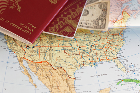 Passport and US dollar bill on a map of the United Statesの写真素材