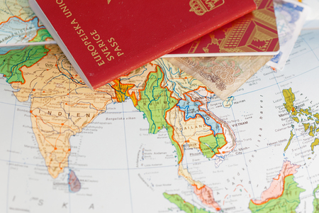 Passport and on a map of Asia including India, Thailand, Vietnam and Burmaの写真素材
