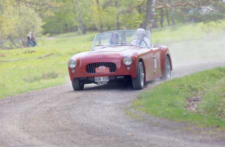 STOCKHOLM, SWEDEN - MAY 22, 2017: Red Allard Oetta classic car from 1953 driving on a country road in the public race Gardesloppet in the forests at Djurgarden, Stockholm, Sweden. May 22, 2017のeditorial素材