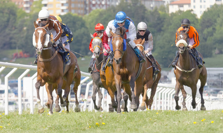 STOCKHOLM, SWEDEN - JUNE 06: Tough race between the race horses and colorful jockeys at Nationaldags Galoppen at Gardet. June 6, 2017 in Stockholm, Swedenのeditorial素材