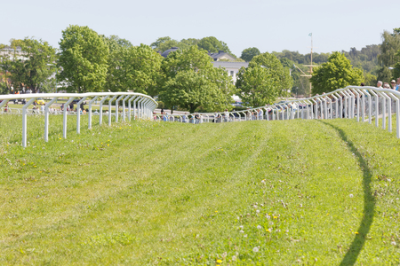 STOCKHOLM, SWEDEN - JUNE 06, 2017: The gallop horse race hippodrome, trees in the background at Nationaldags Galoppen at Gardet. June 6, 2017 in Stockholm, Sweden