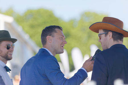 STOCKHOLM, SWEDEN - JUNE 06, 2017: Presenter Per Skoglund interview people on stage at Nationaldags Galoppen at Gardet. June 6, 2017 in Stockholm, Swedenのeditorial素材