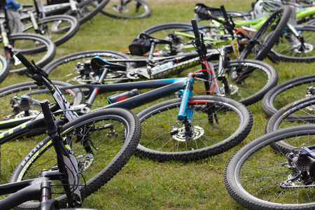 STOCKHOLM, SWEDEN - JUNE 11, 2017: Lots of mountainbikes laying in the grass before the start in the...