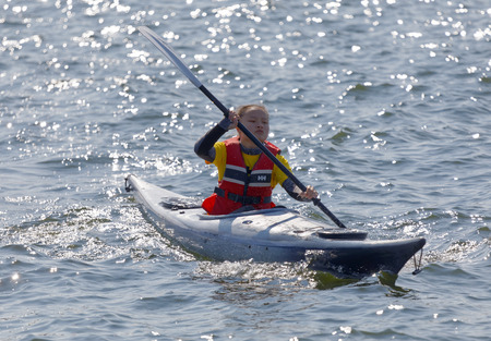 STOCKHOLM - AUG 26, 2017: Official in a canoe ready to help the triathlets in the Women's ITU World Triathlon series event August 22, 2017 in Stockholm, Swedenのeditorial素材