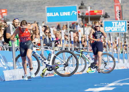 STOCKHOLM - AUG 26, 2017: Female leading duo triathlete Duffy and Learmonth running in the transition zone in Stockholm running in the transition zone in the Women's ITU World Triathlon series event August 26, 2017 in Stockholm, Swedenのeditorial素材