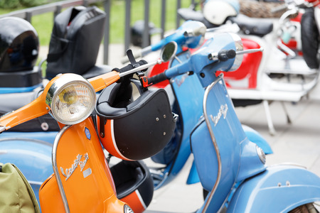 STOCKHOLM, SWEDEN - SEPT 02, 2017: Closeup of helmets and handlebars on old fashioned classic vespa scooter from the 60s at the Mods vs Rockers event at the Saint Eriks bridge, Stockholm, Sweden, September 02, 2017のeditorial素材
