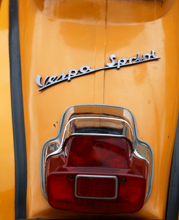 STOCKHOLM, SWEDEN - SEPT 02, 2017: Closeup of the back of a yellow old fashioned classic vespa spirit scooters at the Mods vs Rockers event at the Saint Eriks bridge, Stockholm, Sweden, September 02, 2017のeditorial素材