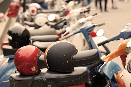 STOCKHOLM, SWEDEN - SEPT 02, 2017: Retro MC helmets on old fashioned vespa scooter and other scooters in the background at the Mods vs Rockers event at the Saint Eriks bridge, Stockholm, Sweden, September 02, 2017のeditorial素材