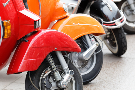 STOCKHOLM, SWEDEN - SEPT 02, 2017: Closeup of  wheels of parkedcolorful red, orange and black old fashioned vespa scooters  at the Mods vs Rockers event at the Saint Eriks bridge, Stockholm, Sweden, September 02, 2017のeditorial素材