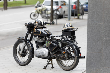 STOCKHOLM, SWEDEN - SEPT 02, 2017: TBeautiful black old retro motorcycle and helmet on the tank at the Mods vs Rockers event at the Saint Eriks bridge, Stockholm, Sweden, September 02, 2017のeditorial素材