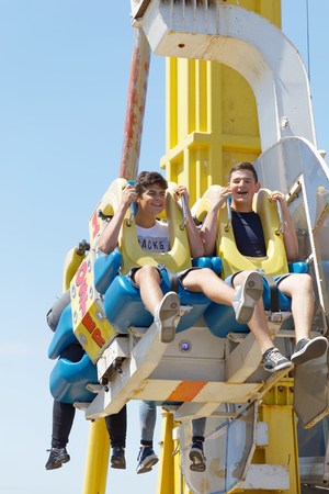 BRIGHTON, GREAT BRITAIN - JUN 15, 2017: Laughing kids riding an attaction in the amusement park on the Brighton Pier. June 15, 2017 in Brighton, Great Britainのeditorial素材