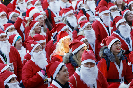 STOCKHOLM, SWEDEN - DEC 10, 2017: Many Santas in traditional red dresses and beard in the Stockholm Santa Run in Sweden, December 10, 2017のeditorial素材