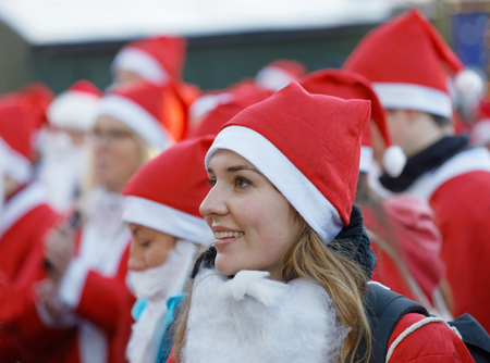 STOCKHOLM, SWEDEN - DEC 10, 2017: Smailing female Santa in traditional red dress and beard in the Stockholm Santa Run in Sweden, December 10, 2017のeditorial素材