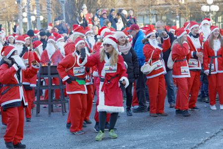 STOCKHOLM, SWEDEN - DEC 10, 2017: Many happy Santas in traditional red dresses and beard in the Stockholm Santa Run in Sweden, December 10, 2017のeditorial素材