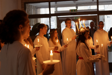 STOCKHOLM, SWEDEN - DEC 13, 2017: Lucia parade with singing girls and boys in white dresses holding...